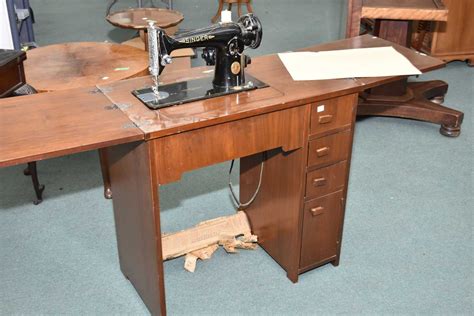 value of vintage steel singer sewing machine in wood cabinet|identifying singer sewing machine cabinets.